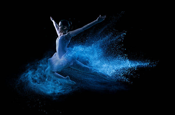 istock Young beautiful dancer jumping into blue powder cloud 462340969
