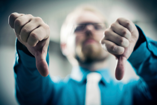 Businessman Showing Thumbs Down Gesture in Strong Toned Image