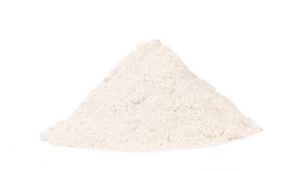 A triangular mound of wheat flour on white background Front view of wheat flour. Isolated on a white background. powder mountain stock pictures, royalty-free photos & images