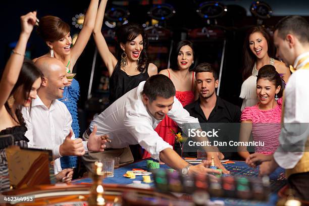 Happy Caucasian Friends Playing Roulette In Casino Stock Photo - Download Image Now - Adult, Beautiful People, Beauty