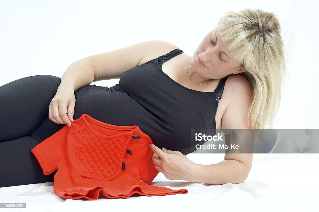 Pregnancy pregnant woman with baby clothes 6-11 Months Stock Photo