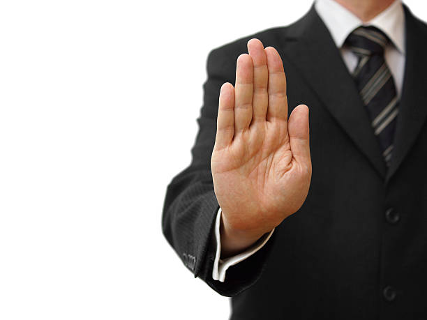 istock Businessman showing stop sign on neutral background 462351701