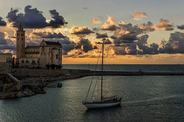 Harbor at sunset: Romanesque cathedral of San NIcola Pellegrino.