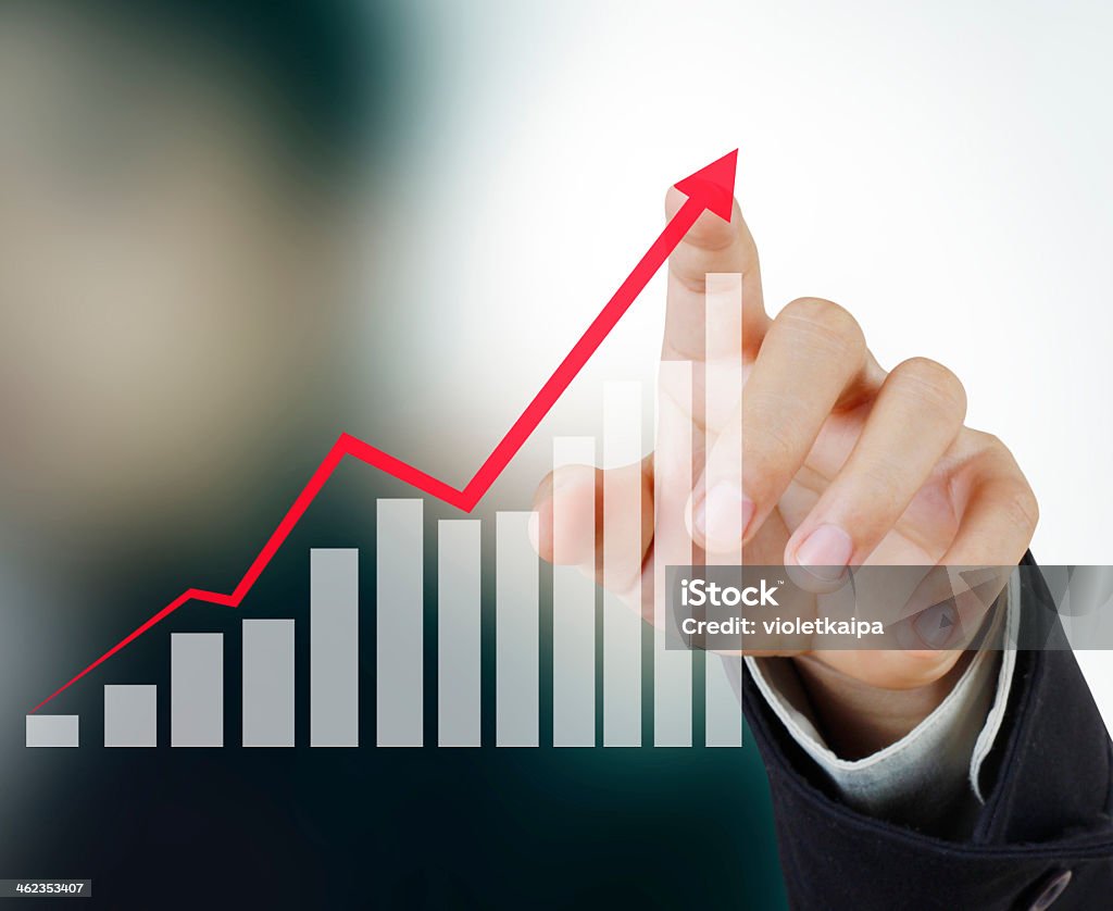 Pointing to upward financial symbol businessman with financial symbols coming from hand Chart Stock Photo