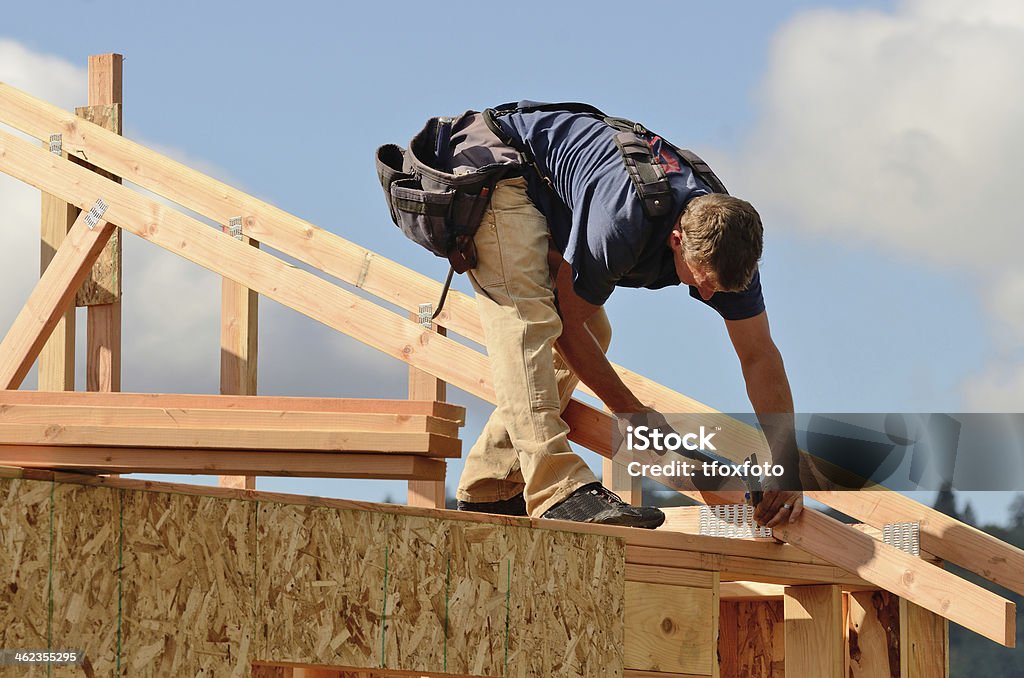 Roof Rafter Layout and installation of roof rafters on a new commercial residential construciton project by framing contactors Carpenter Stock Photo
