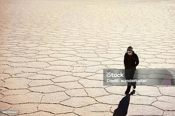 Woman Walking Across Salt Flats Stock Photo - Download Image Now - Hexagon, People, Salar de Uyuni