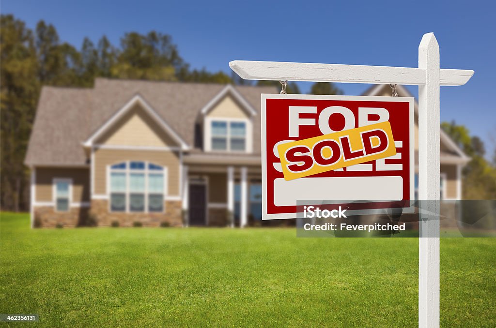 Sold Home For Sale Sign in Front of New House Sold Home For Sale Real Estate Sign in Front of Beautiful New House. Sold - Single Word Stock Photo