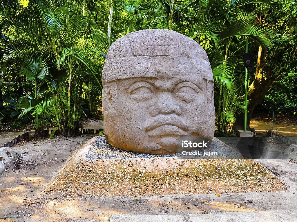 Colossal Olmec Stone Head - Villahermosa, Mexico Thought to have been carved in 700BC, the colossal stone head, along with three others are the most famous monumental artifact in La Venta (now in Villahermosa), Mexico. Olmec Head Stock Photo
