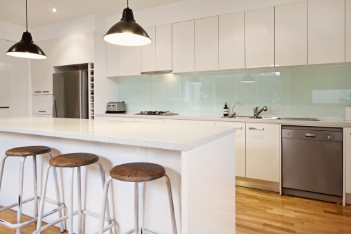 White contemporary kitchen with island and bar stools
