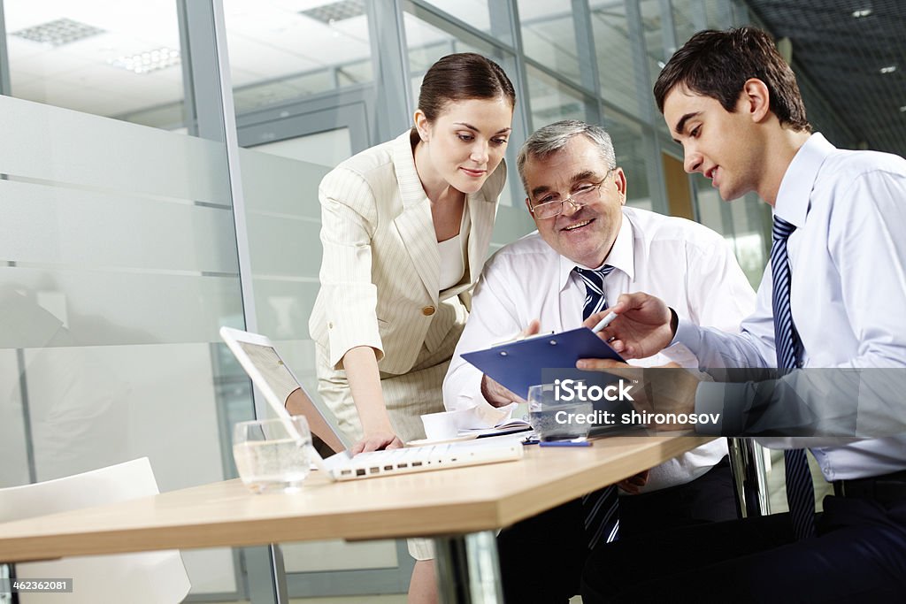 Meeting Three business partners sitting in office and sharing their ideas Active Seniors Stock Photo