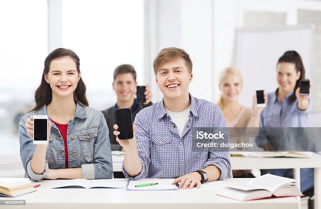 students showing black blank smartphone screens education, technology and internet - smiling students showing black blank smartphone screens at school Animal Stock Photo