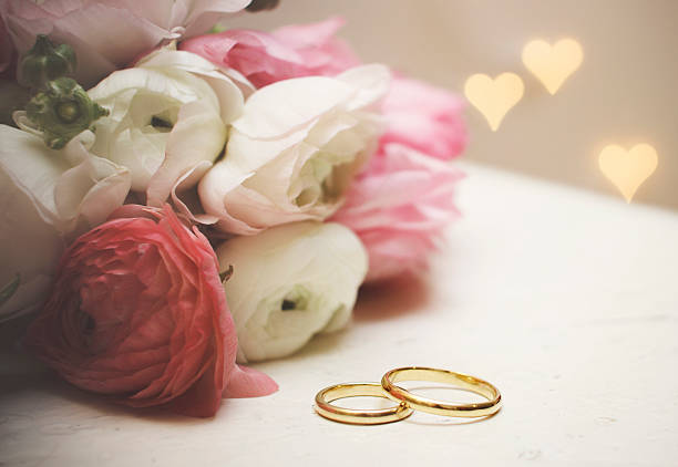 istock Wedding invitation. Ranunculus with wedding rings on vintage table 462367471