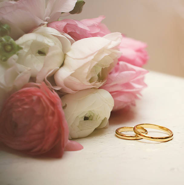 istock ranunculus with wedding rings on vintage table 462367473
