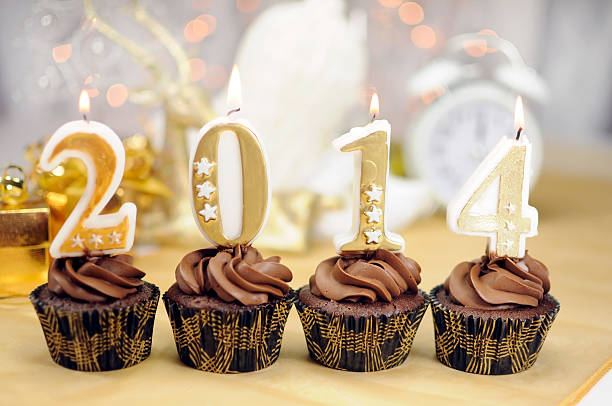 istock Happy New Year chocolate cupcakes with 2014 candles 462372079