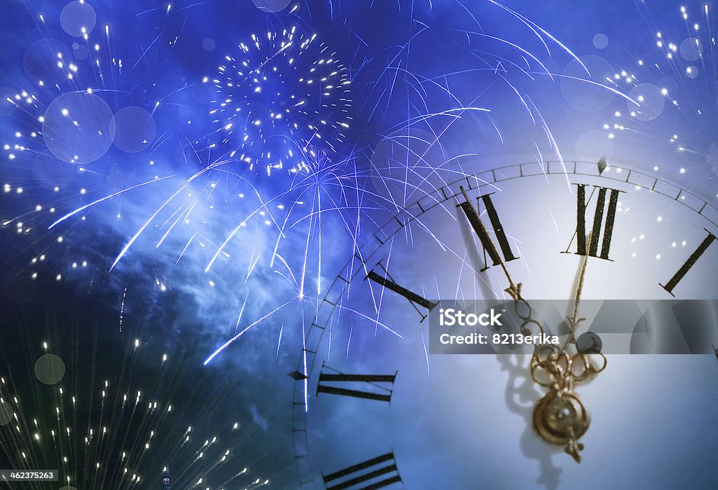 Vintage clock against holiday lights New Year's at midnight ireworks and holiday lights Clock Stock Photo