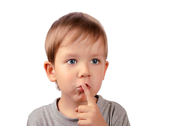 istock cut boy covers up his mouth with finger 462375977