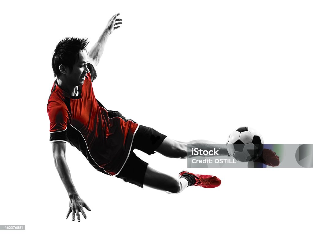 asian soccer player young man silhouette one asian soccer player young man kicking in silhouette white background Soccer Player Stock Photo