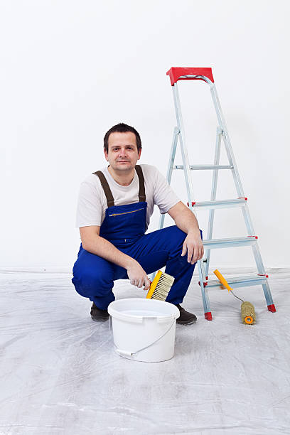 istock Worker with paint, brush and ladder 462377233