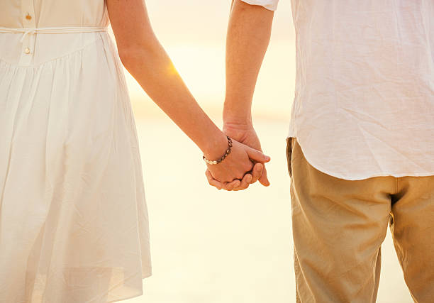 istock Young couple in love on the beach sunset 462382491