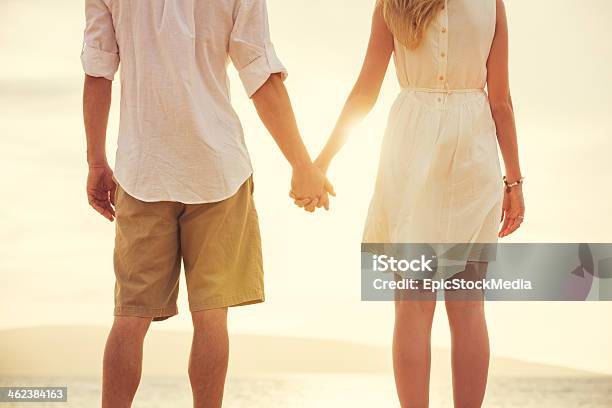 Young Couple In Love On The Beach Sunset Stock Photo - Download Image Now - Walking, Young Couple, Beach