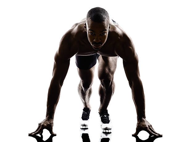 istock young african muscular build man on starting blocks silhouette 462384695