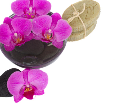 wet zen stones, orchid and organic soap isolated on white background