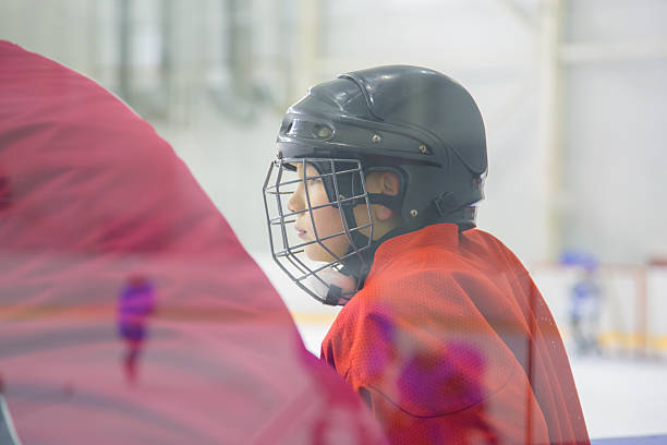 istock A young hockey player with the helmet on 462389721