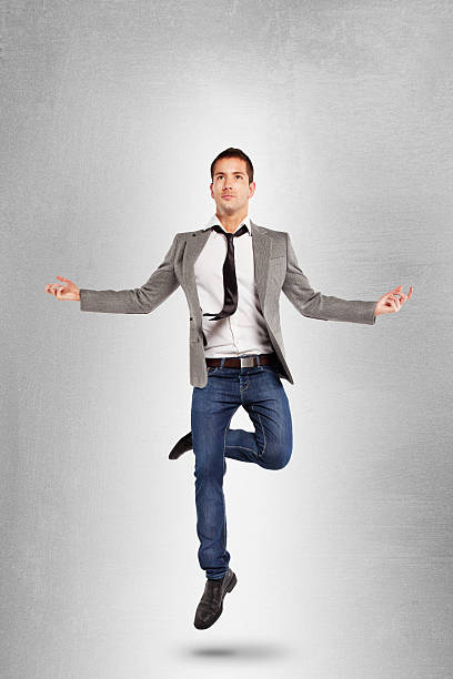 młody biznesmen skoki w pozycji jogi. - men businessman jumping levitation zdjęcia i obrazy z banku zdjęć