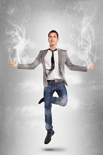 młody biznesmen skoki w pozycji jogi z dymu. - men businessman jumping levitation zdjęcia i obrazy z banku zdjęć