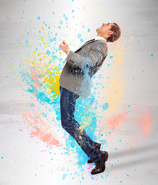 istock Young businessman screaming on splash colored 462392923