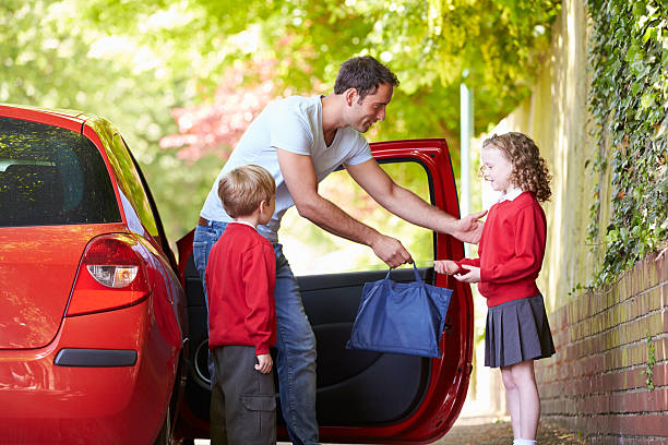 istock Father Driving To School With Children 462398949