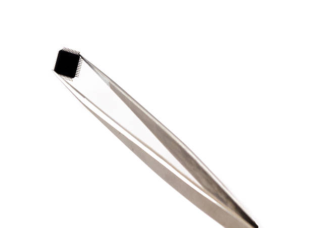 istock Microchip on Tweezers isolated in white 462399077
