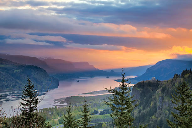 Sunrise Over Crown Point at Columbia River Gorge Sunrise Over Vista House on Crown Point at Columbia River Gorge in Oregon with Beacon Rock in Washington State pacific northwest stock pictures, royalty-free photos & images