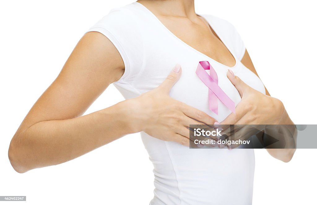 woman with pink cancer awareness ribbon healthcare, people and medicine concept - woman in blank t-shirt with pink breast cancer awareness ribbon checking breast Cancer - Illness Stock Photo