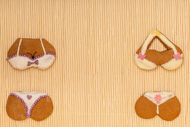 istock Funny colorful bikini shape gingerbread cakes cookies on bamboo mat 462403227