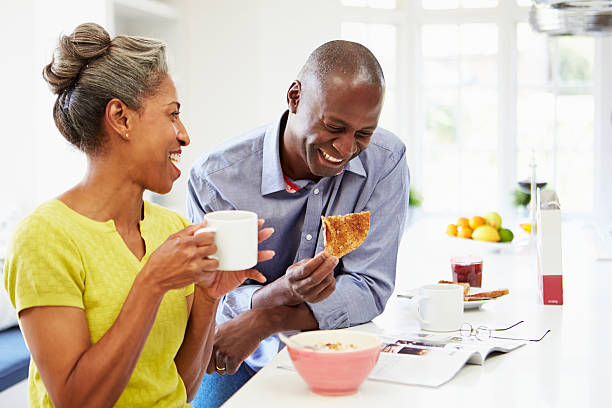 Laughing African American couple has breakfast