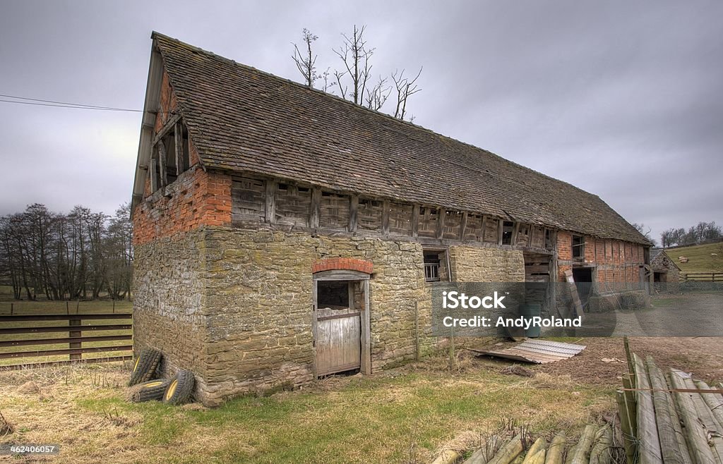 Landscape shot of Shropshire barn building on cloudy day Stone barn with traditional wattle infill panels, Shropshire, England. Barn Stock Photo