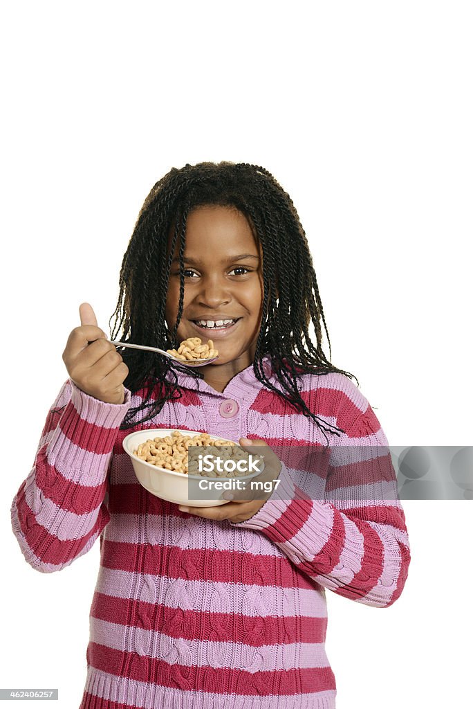little black girl enjoying bowl of cereal isolated little black girl enjoying bowl of cereal Breakfast Cereal Stock Photo