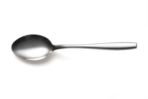 the metal shiny spoon on white background