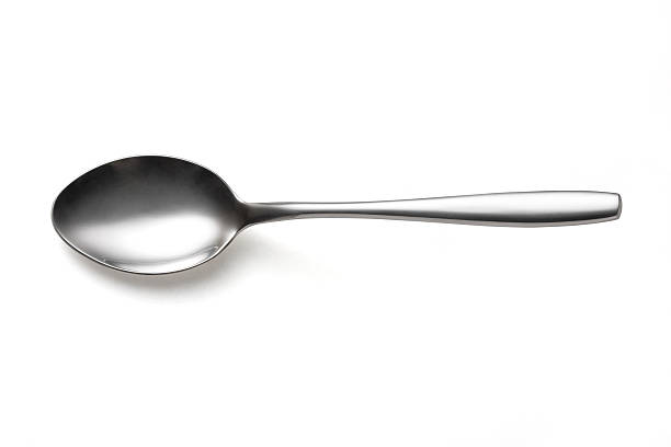 Spoon the metal shiny spoon on white background spoon photos stock pictures, royalty-free photos & images