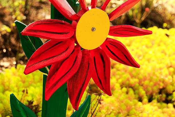 Yellow wind turbine at the garden fence
