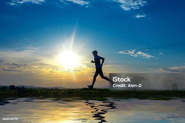 Silhouette Man Running On Meadow Over River Stock Photo - Download Image Now - Active Lifestyle, Activity, Adult