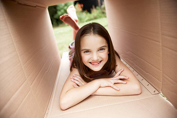 istock Girl Lying In Cardboard Box 462411047