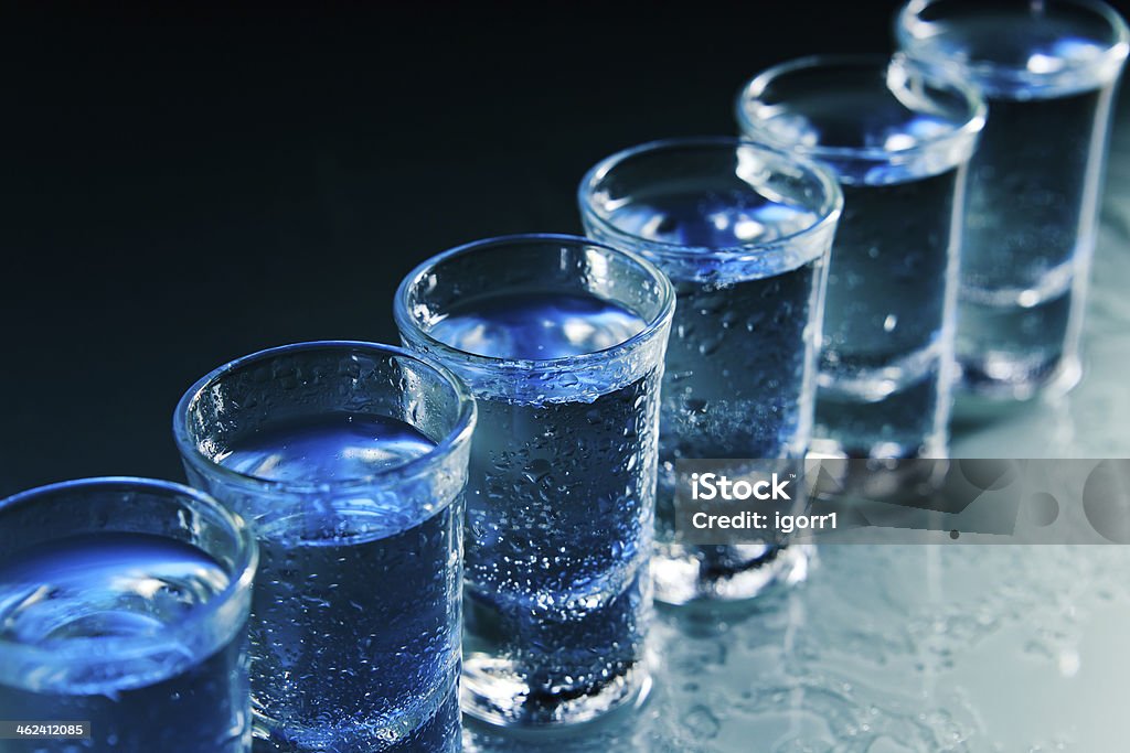 Glasses with an alcoholic drink Glasses with an alcoholic drink on a damp glass table Alcohol - Drink Stock Photo