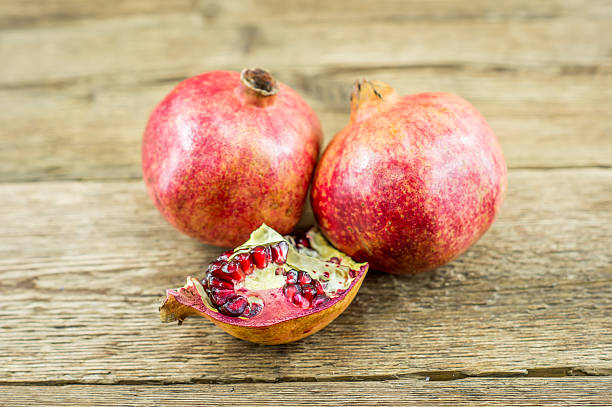istock Pomegranate isolated on wooden background 462416707