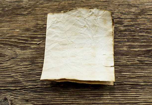 istock old paper on wood background 462419403