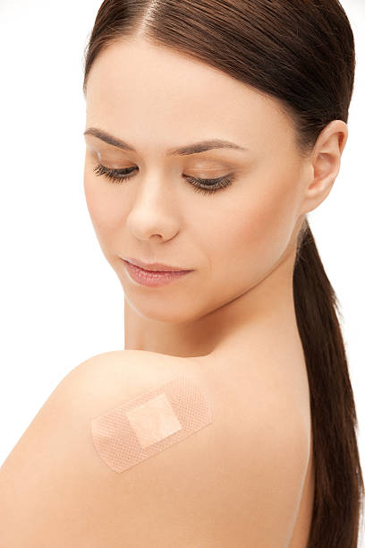 istock beautiful woman with medical patch or plaster 462429339