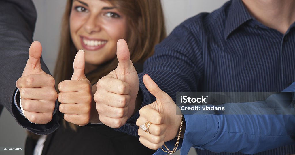 Thumbs up portrait Portrait of a young woman who is a member of a successful business team. Focus on thumbs. 20-29 Years Stock Photo