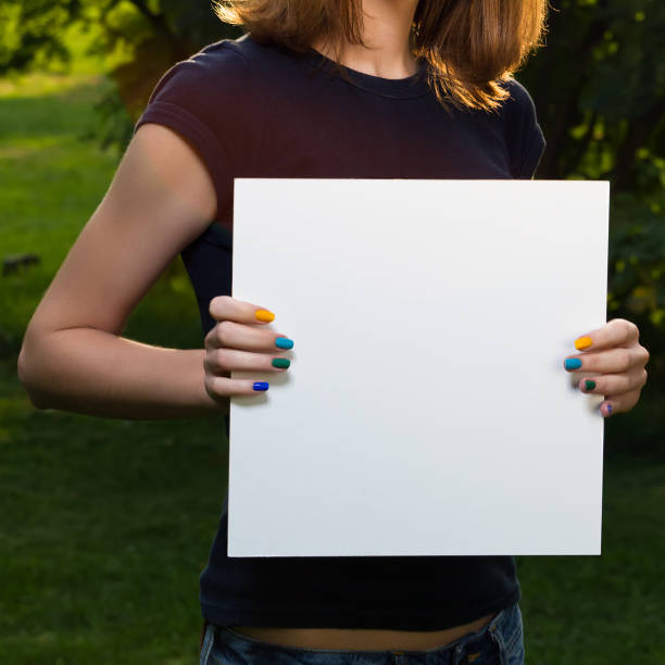 istock Young girl holding white paper 462433943