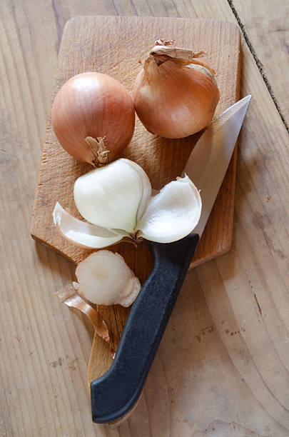 istock onions are peeled on a wooden board 462436225